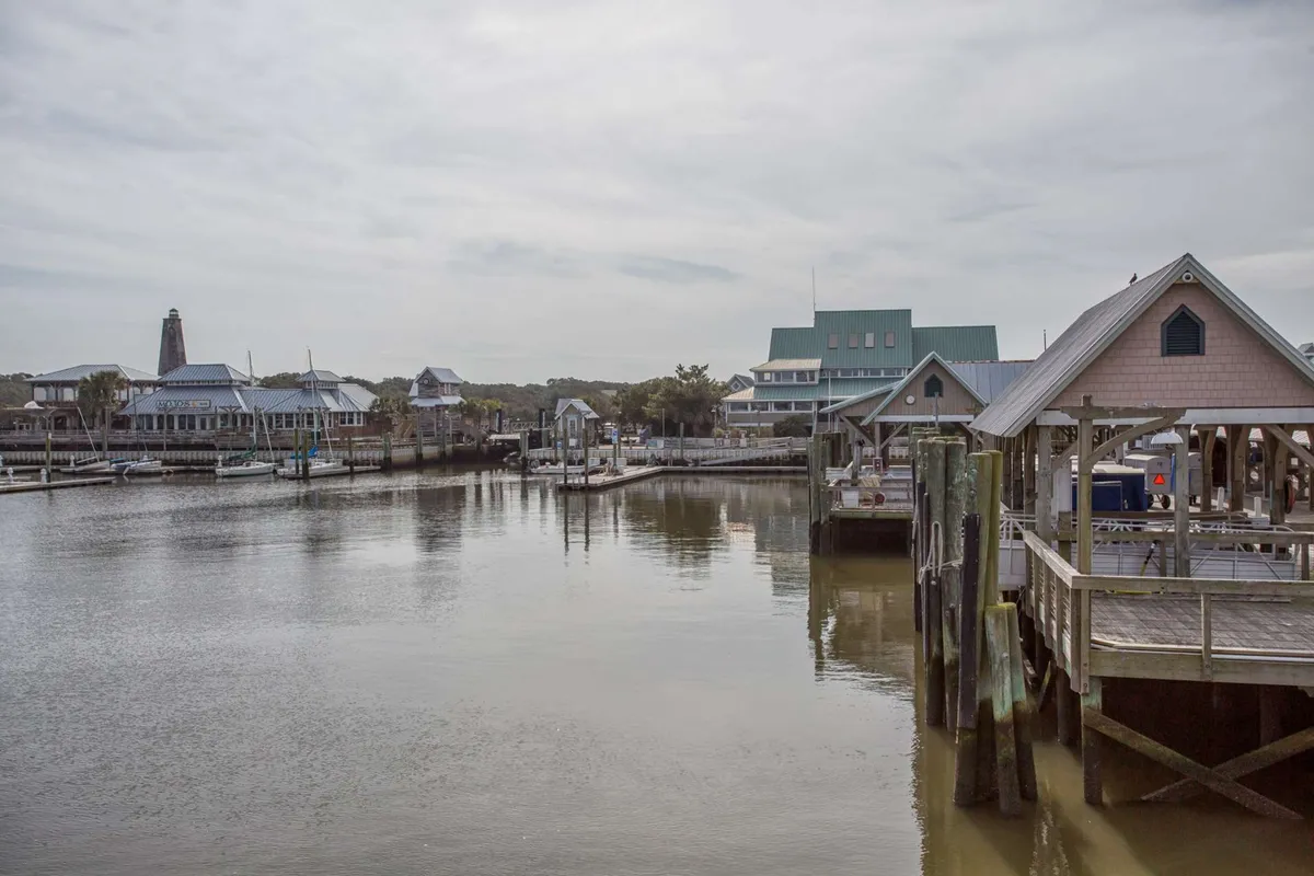 Vibrant marina with boats docked along the water, waterfront buildings, and outdoor seating areas. The scene captures the atmosphere of the marina district, where guests can enjoy boating, dining, and picturesque sunsets.